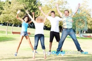 family-jumping-high-in-the-air-on-a-green-meadow-10053478